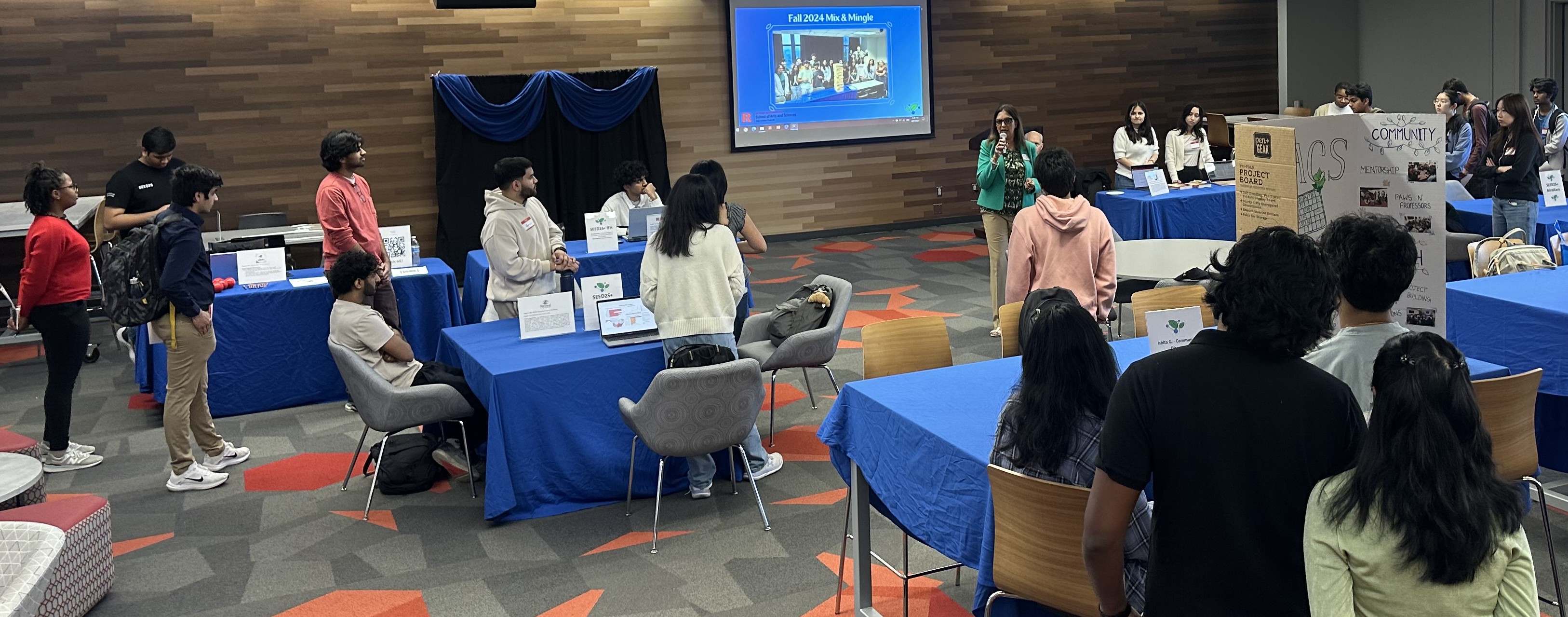 (l. to r.) Jessica Kluge NCAS'19, Bobbi Fiorello NCAS'19 and Andreina Minaya NCAS'18 ask Associate Professor of Psychology Gretchen Van de Walle for help