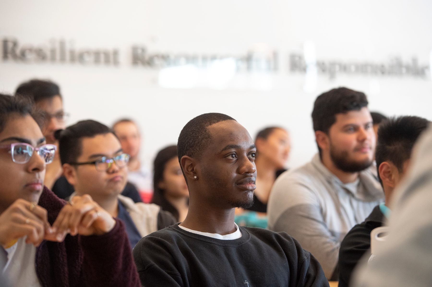 Students listen to guest speaker alum Michael Miller during Assistant Professor of Professional Practice Mukesh Patel's innovations class in Business School 100 Rock on Livingston Campus