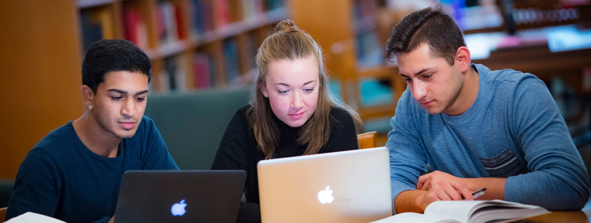 Yash Patel (SAS '19) Brooke Greene (SAS '19) and Dante Cuzzolino (RBS '19) study in Alexander Library